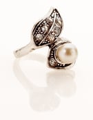 Image of Faux pearl and white stone encrusted ring.