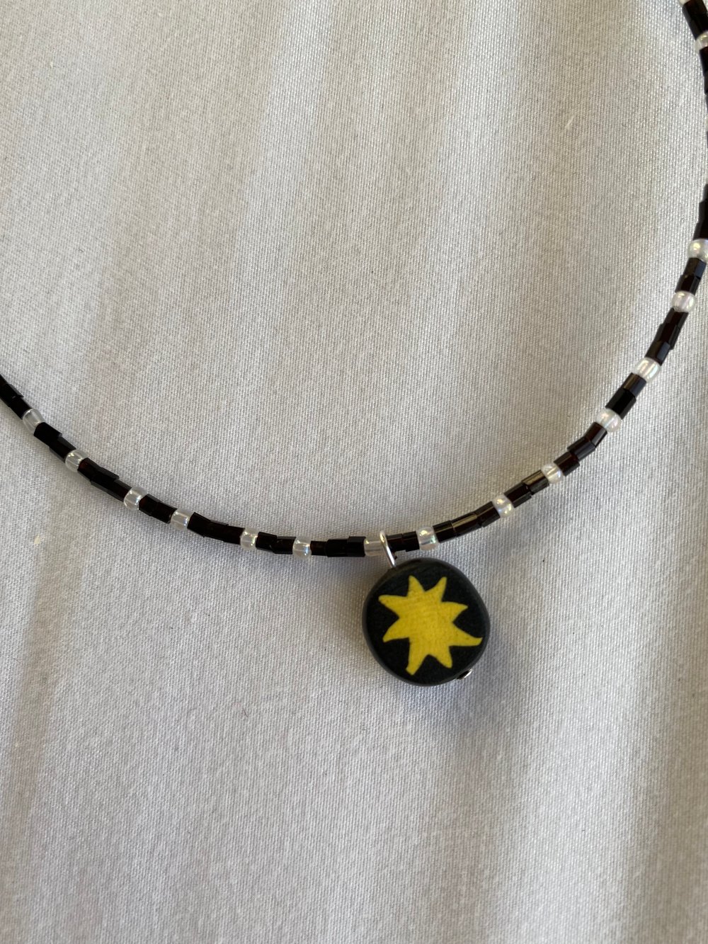 Image of black and white star charm necklace