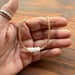 Image of Waterproof 7 tiny pukas choker necklace on hand braided sinew with locking seaglass clasp