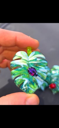 Image 3 of Uv reactive Variegated monstera leaf pendant with purple ladybug 