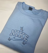 Image 1 of  Embroidered butterfly crew neck blue sweatshirt