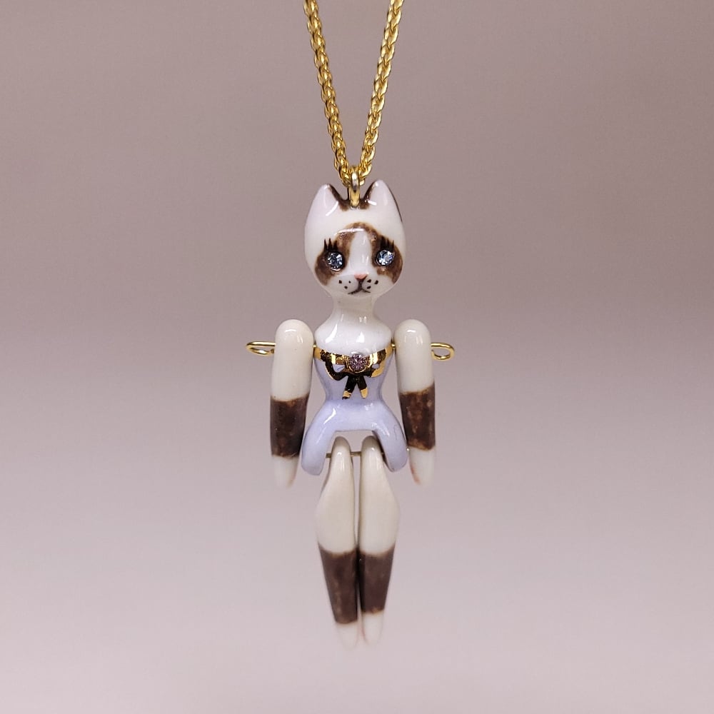 Image of Snowshoe Porcelain & Gold Vermeil Articulated Doll Pendant