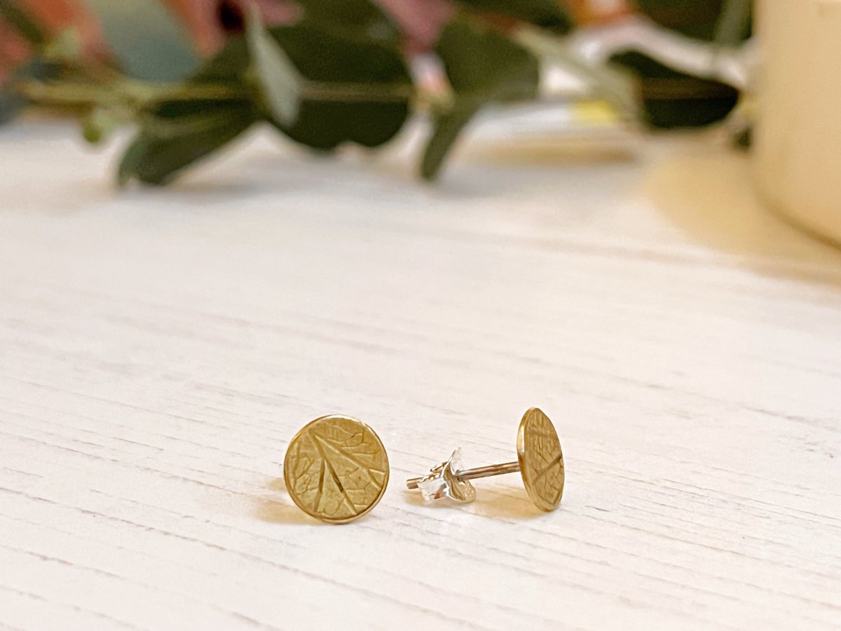 Image of Brass disc stud earrings with hydrangea petal imprint detail. Sterling silver posts.