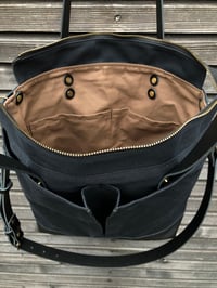 Image 3 of Black waxed canvas tote bag with leather bottom handles and cross body strap