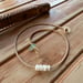 Image of Waterproof 7 tiny pukas choker necklace on hand braided sinew with locking seaglass clasp