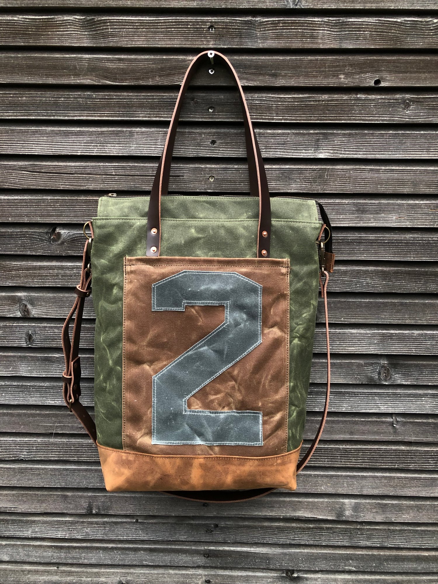 Image of Vertical tote bag made  in waxed canvas with leather straps and cross body strap 