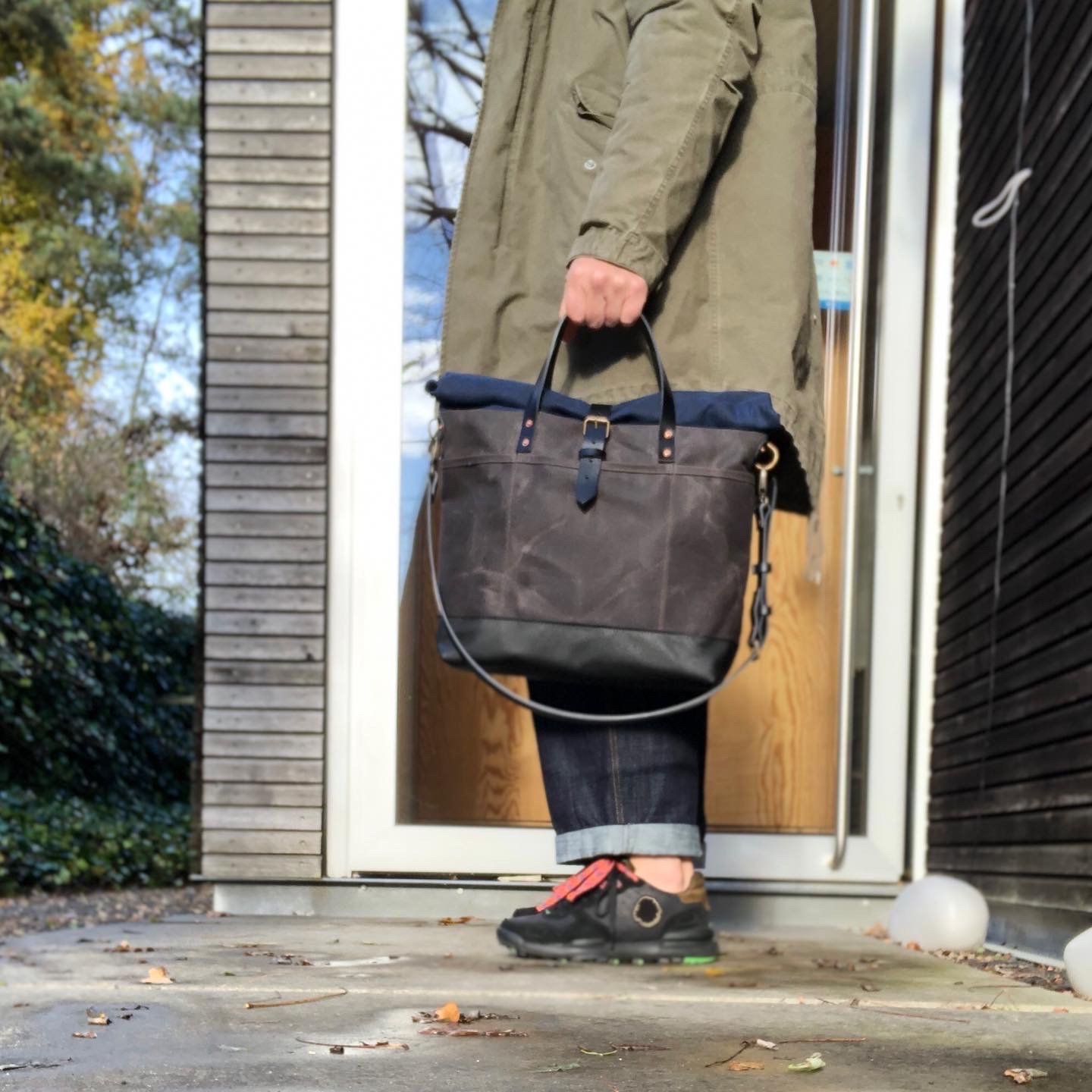 Waxed canvas roll to close top tote bag with luggage handle