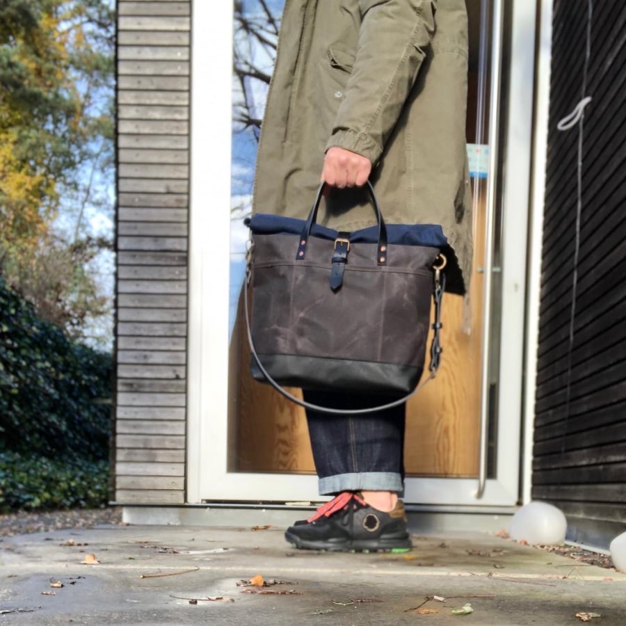 Image of Waxed canvas roll to close top tote bag with luggage handle attachment leather handles and shoul