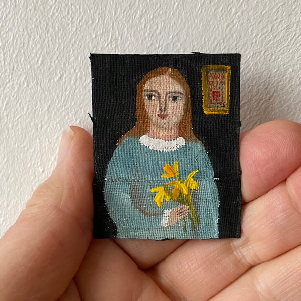 Image of woman in blue with daffodils - very tiny painting 