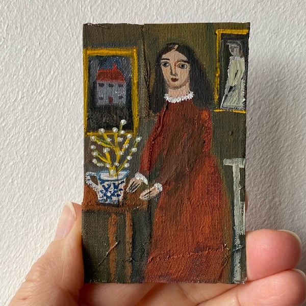 Image of Woman in dark red with house painting - tiny portrait 