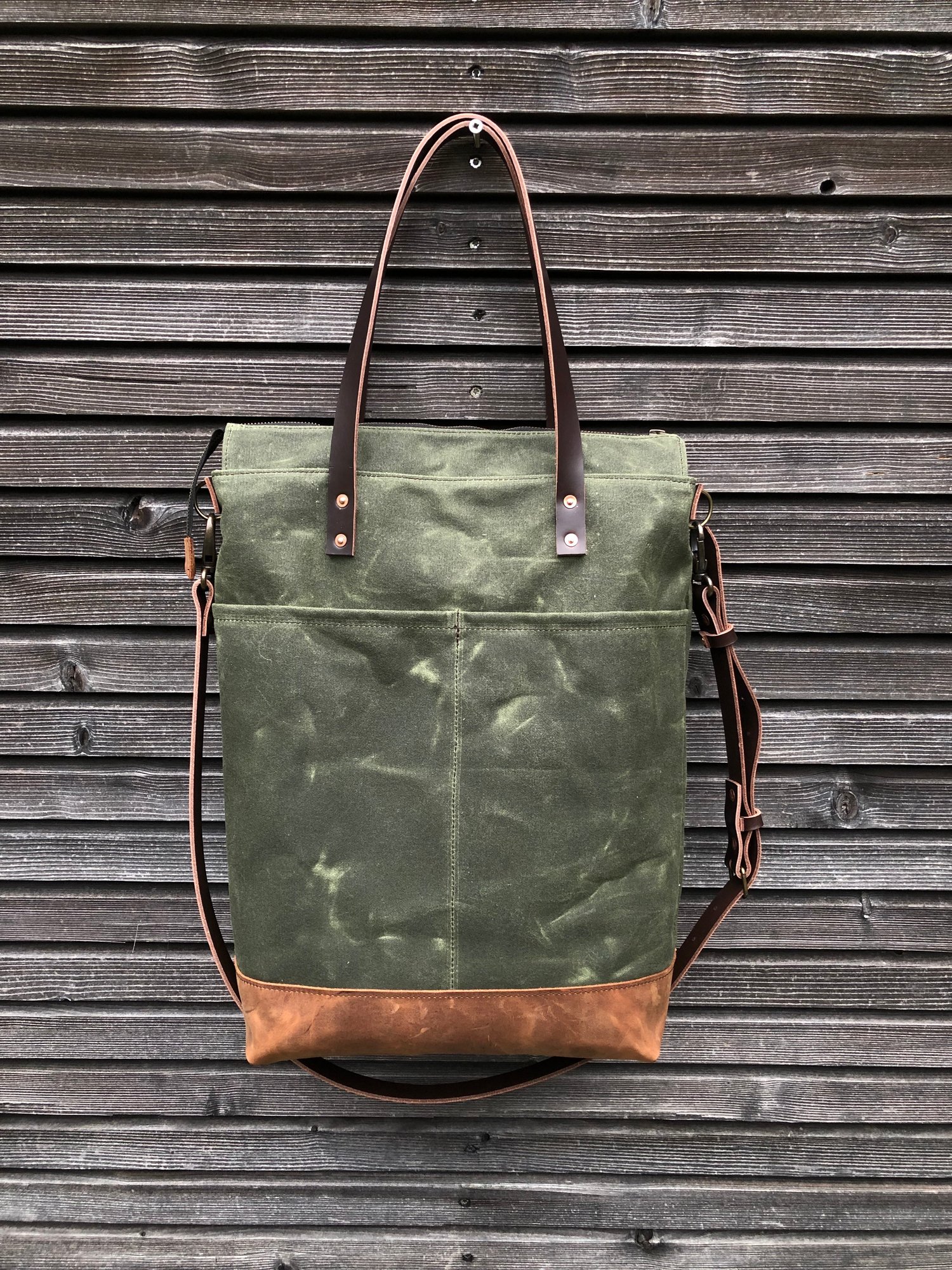 Image of Vertical tote bag made  in waxed canvas with leather straps and cross body strap 