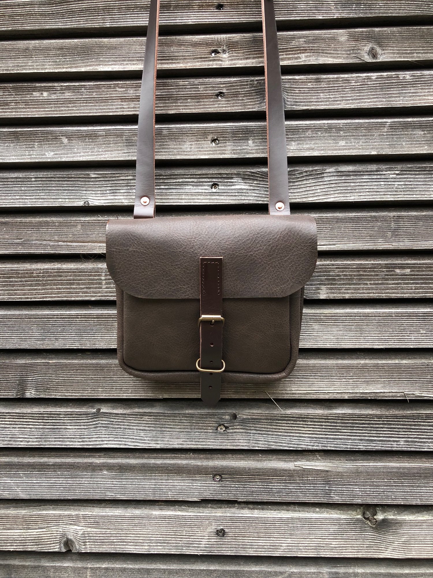 Image of Daybag in dark brown oiled leather with shoulder strap unisex collection