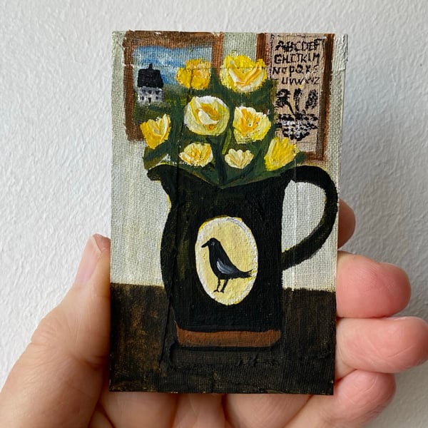 Image of yellow roses in a dark bird jug