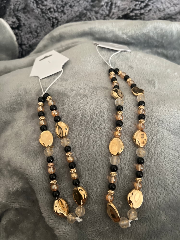 Image of gold theme phone charm 