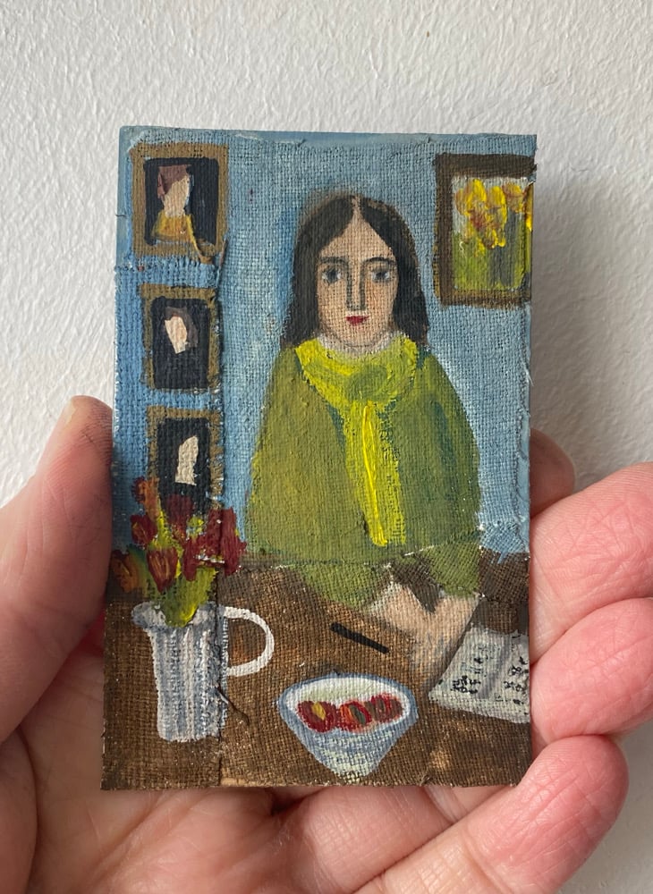 Image of Poet at a table with notebook - tiny painting