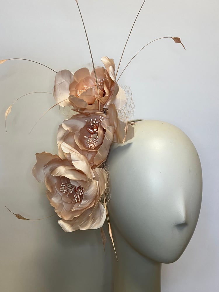 Image of Pale pink silk flower headpiece.