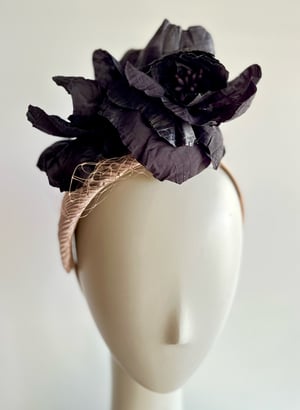 Image of Nude fabric covered shape w black silk flowers