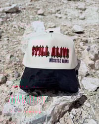 THE “STILL ALIVE” TRUCKER HAT — DURAN EDITION