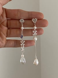 Image 1 of violet skull earrings