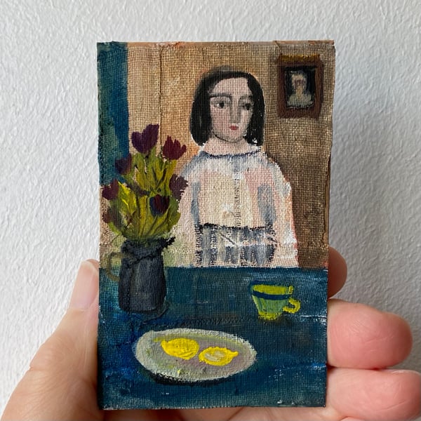Image of woman at a table with dish of lemons