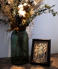 Image 1 of Molotovheart in gold with leo background