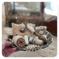 Image 4 of Vintage style tattered square pin cushion sitting on a tray full of sewing notions