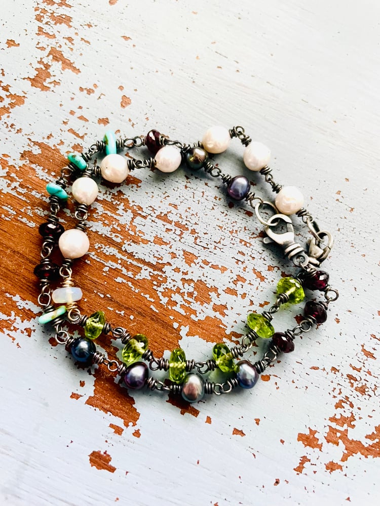 Image of peacock pearl and garnet bracelet