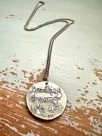 Image 16 of blue sapphire pendant with Fitzgerald quote