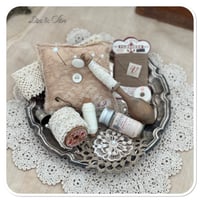 Image 5 of Vintage style tattered square pin cushion sitting on a tray full of sewing notions