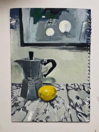 Coffeepot and lemon on marble surface