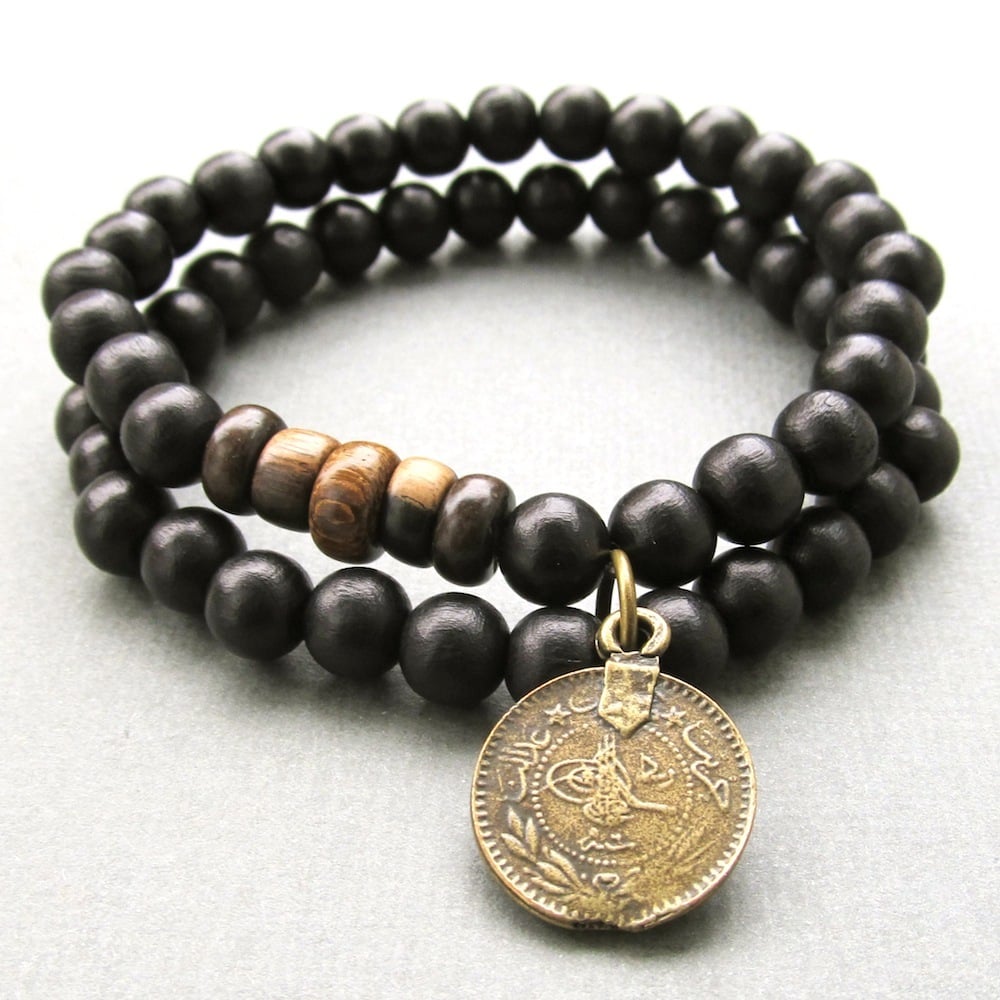 Double black beaded stretch bracelet with coin charm Jewellery by Lowusu