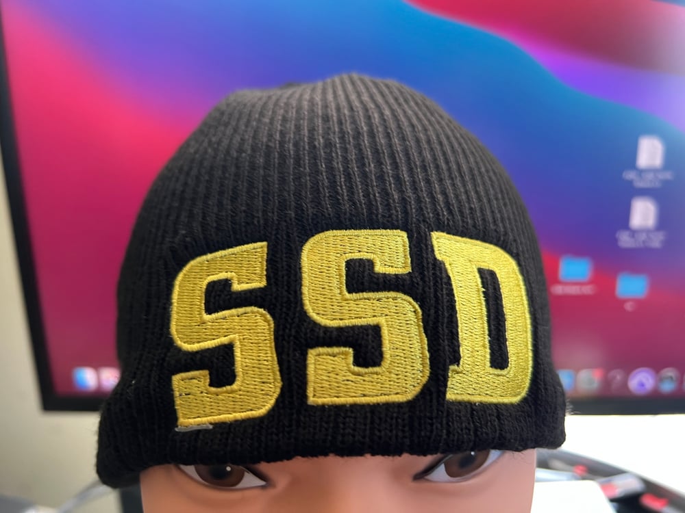 Black New Era Knit beanie hat with Solid Yellow SSD logo 