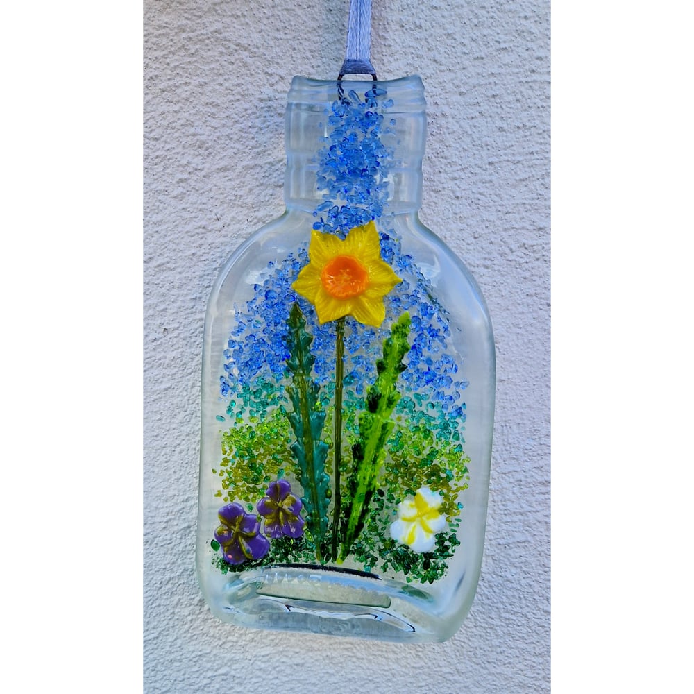 Image of Fused Bottle with Daffodil and Violas.