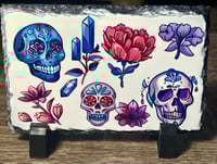 Skulls and crystals rock slate 