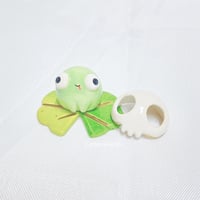 Image 1 of Silly Frog On Lily Pad With Skull Mask Ceramic Figurine