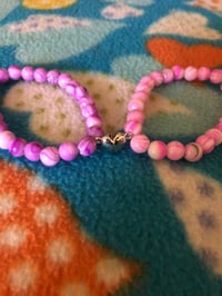 Image 2 of matching bracelets 💗💜