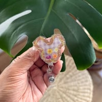 Image 1 of Magical Pua Kalaunu Lei Palaka Shaker Badge Reel