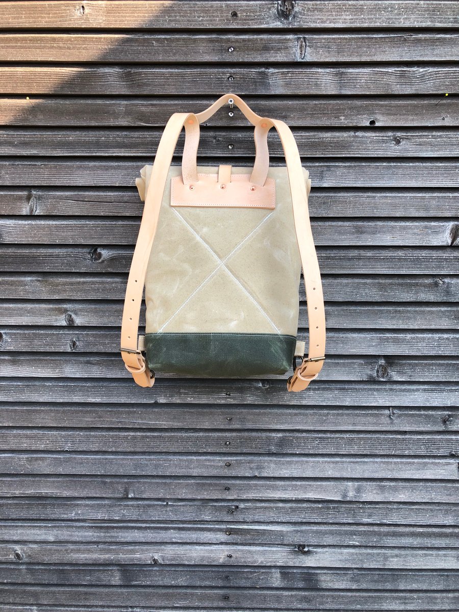 Image of Small waxed canvas backpack  in natural  with rolled top and leather shoulder straps