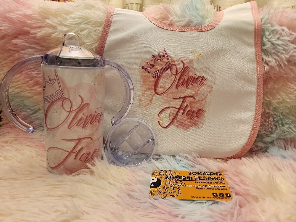 Image of Sippy cup with baby bib or puzzle