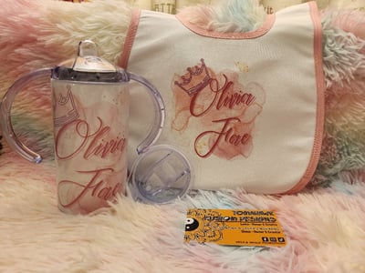 Image of Sippy cup with baby bib or puzzle