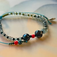 Image 1 of aqua and black pearls bracelet