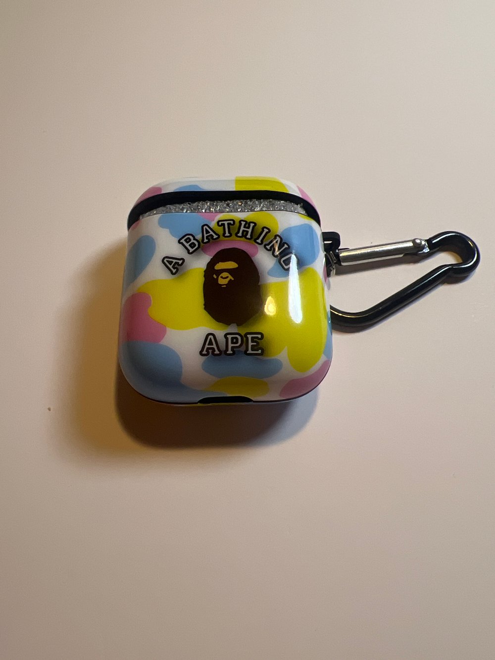 Image of multi color AirPod case shiney