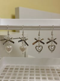 Image 3 of metal bow and heart coquette earrings
