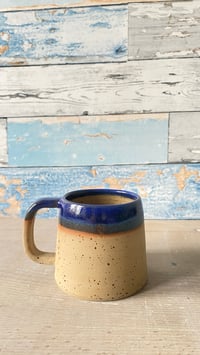Image 1 of Blue rimmed mug.
