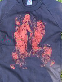 Image 1 of Tight 70s style t shirt black with red/orange pussy print (size 12)