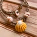 Image of Hawaiian sunrise shell necklace with golden pukas and a locking seaglass clasp
