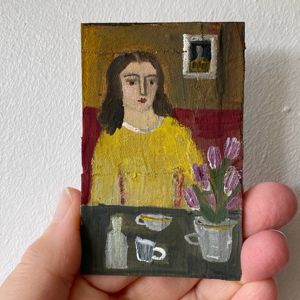Image of woman in yellow at a table with tulips - tiny painting