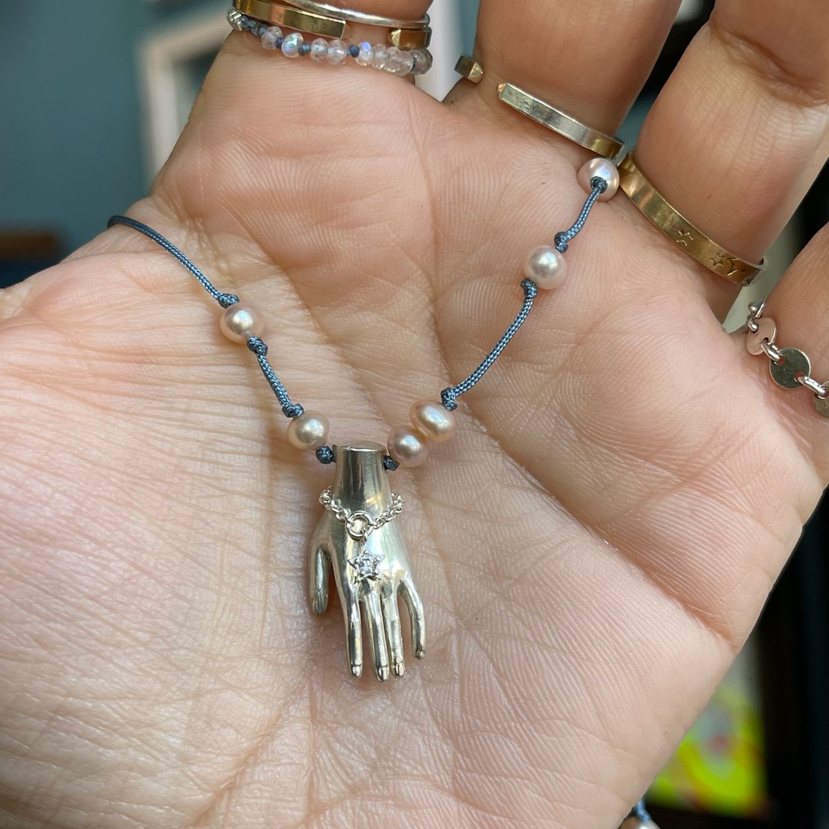Image of hand necklace with pearls