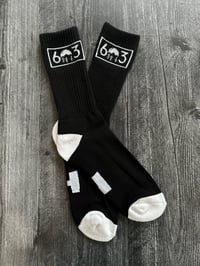 Image 3 of 603 black/white socks with NH on the bottom