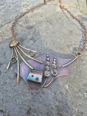 Necklace with a house under a mallow flower